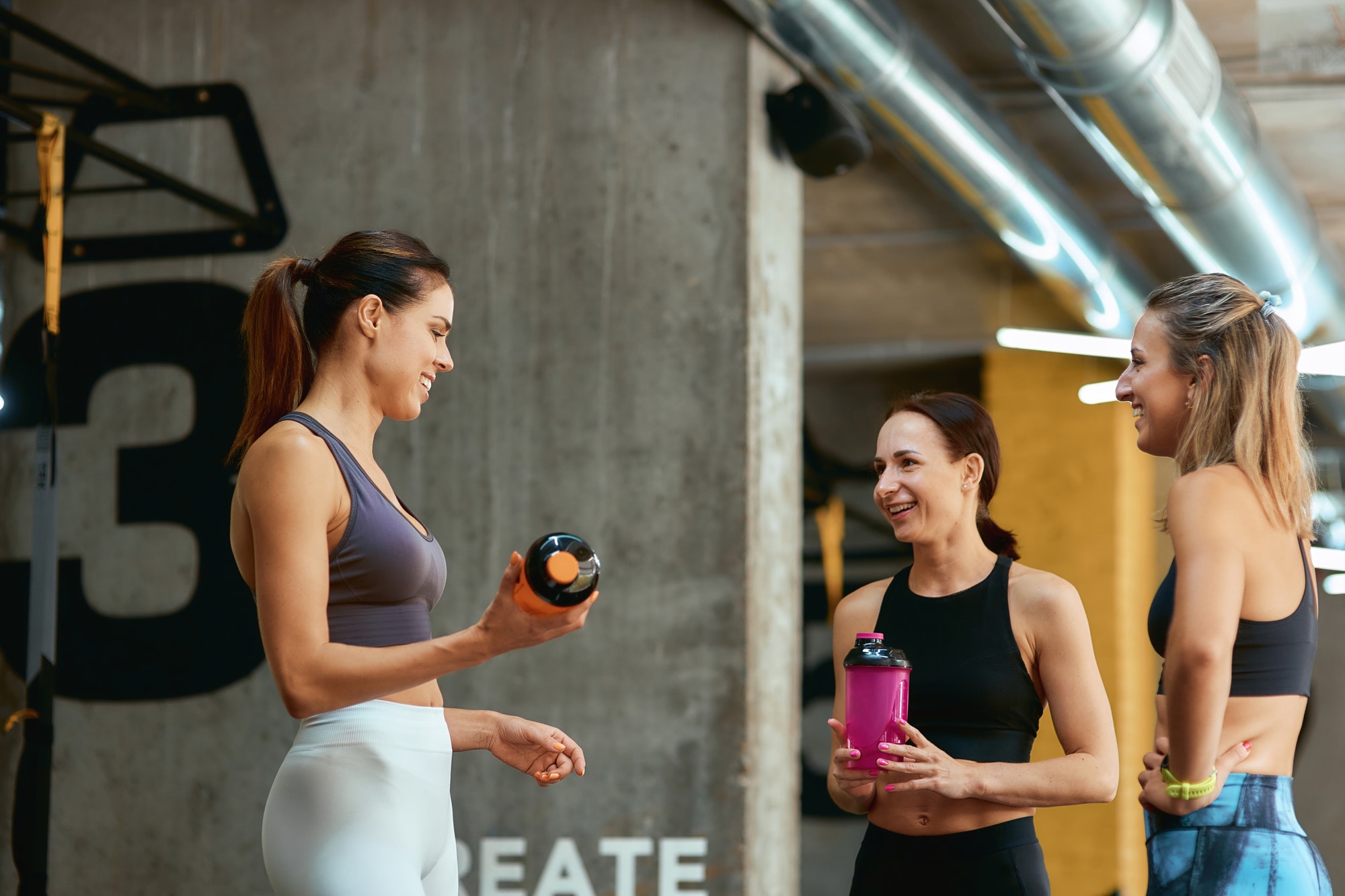 resting-after-workout-group-of-three-young-beautiful-fitness-women-in-sportswear-talking-and.jpg